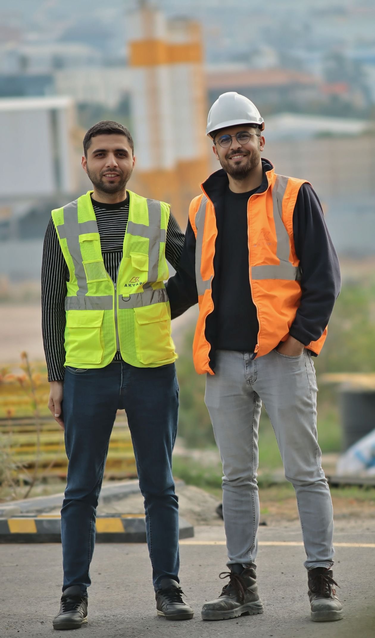 Two construction workers in safety gear reviewing a PTW Day 0 permit application