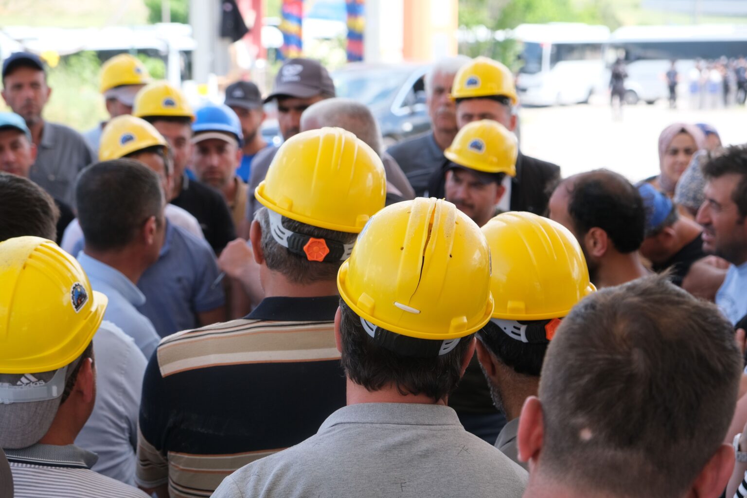 What Is a Toolbox Meeting – PEER What is a toolbox meeting: workers in hard hats gathering for a safety briefing before work