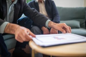 bizSAFE consultant meeting: two professionals discussing risk management documents at a table