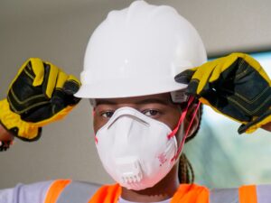 MOM haze guidelines: construction worker wearing a hard hat, N95 mask and gloves